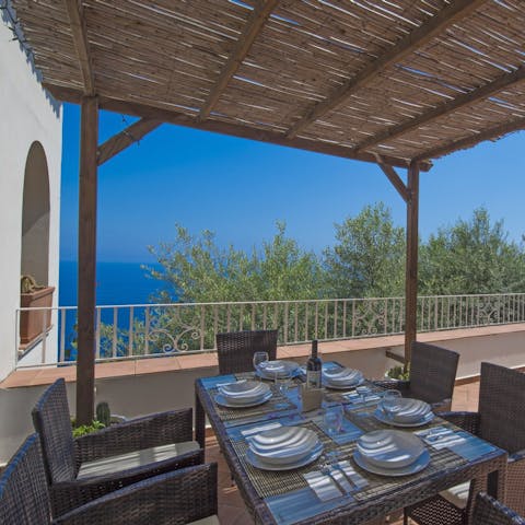 Enjoy an alfresco breakfast under the pergola, with Mediterranean Sea views