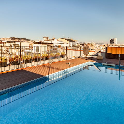 Take a refreshing dip in the communal rooftop pool and gaze across the city