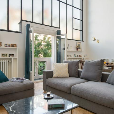 Relax in the bright living room while enjoying the breeze coming through the French doors