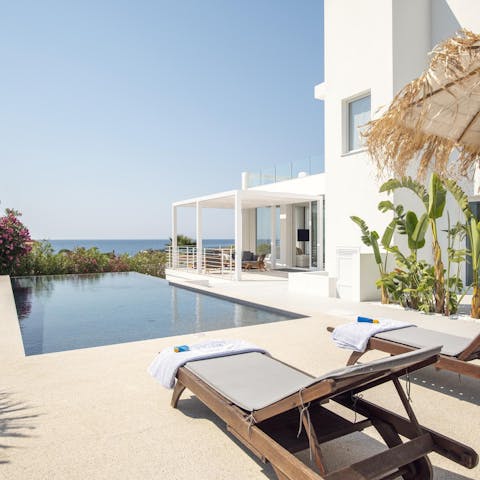 Enjoy views of the Ionian Sea as you relax by the pool
