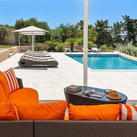Lounge by the private heated pool and soak up the warm sun