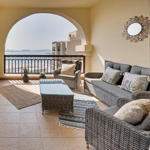 Stretch out on your private balcony overlooking the pristine waters