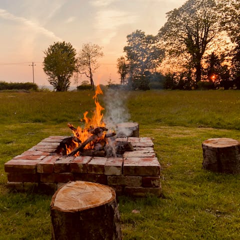 Gather around the fire pit for endless summer sunsets with a cold drink in hand