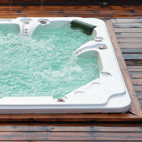 Slip into the hot tub just outside the home and let it melt away all stress