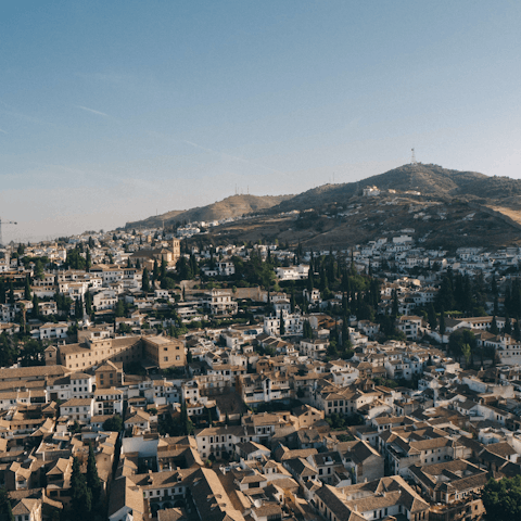 Drive into the vibrant city of Granada with its famous hilltop fortress