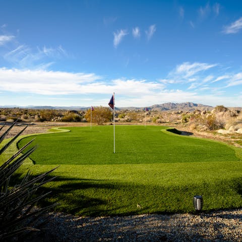 Shoot some holes in the three-hole putting green under the hot desert sun