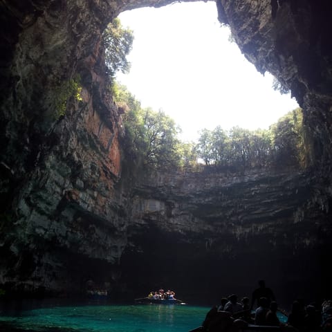 Admire the crystal-clear waters in Melissani Cave, an eight-minute walk from home