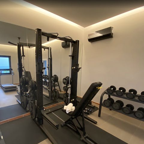 Keep on top of fitness in the private gym with sea views