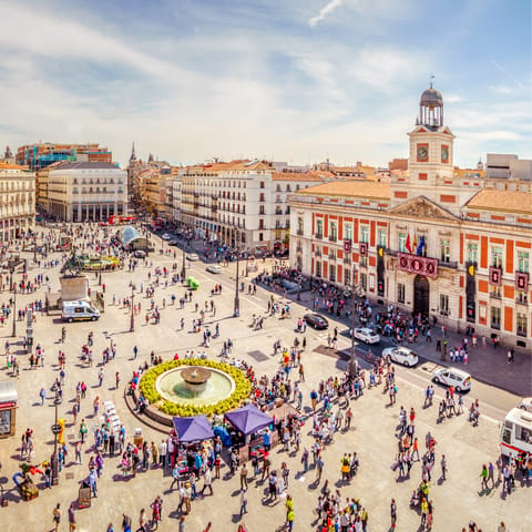 Visit the bustling Puerta del Sol, a five-minute metro ride away