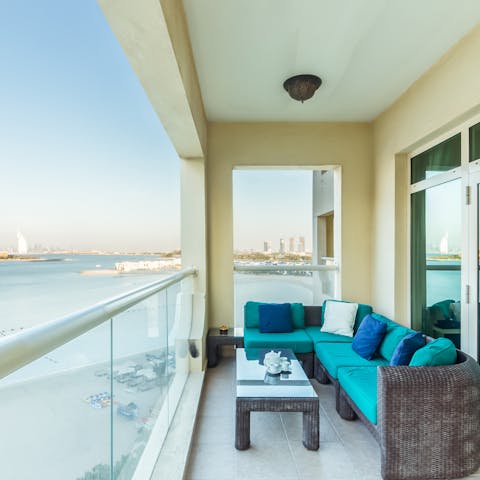 Relax on the beachside balcony with a cold refreshing drink in hand