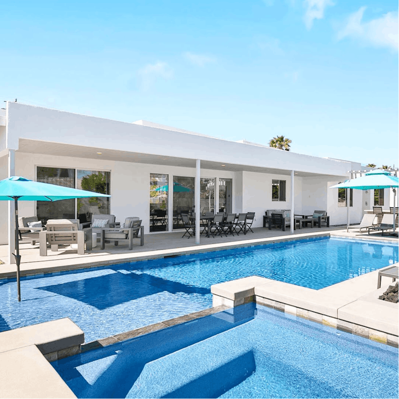Lounge under the sun by the pool or in the waterfall spa