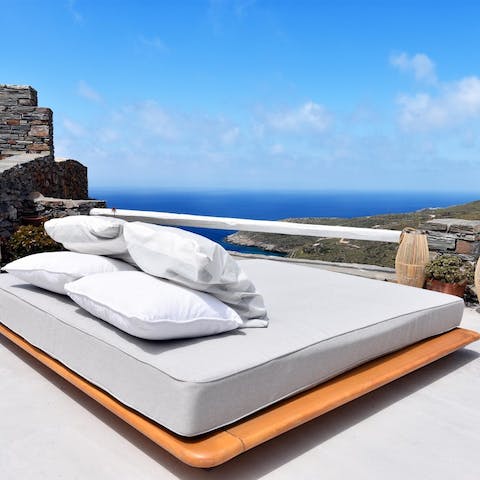 Relax on the day bed and enjoy the ocean views