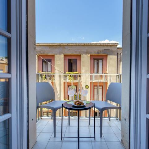 Enjoy an aperitivo on the private balcony at sunset