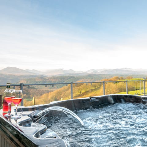 Unwind in the bubbles of the hot tub as you admire the stunning mountain views