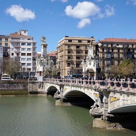 Stay next to the ornate María Cristina bridge