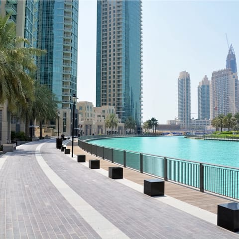 Stroll along Dubai Marina's promenade, soaking up the sun as you go