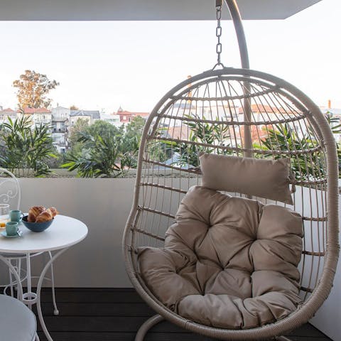 Unwind with a cup of coffee in the hanging egg chair after enjoying breakfast on the balcony