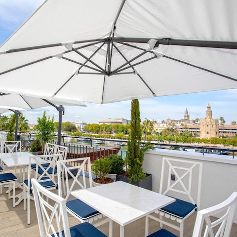 Take in views of Torre del Oro from the shared roof terrace