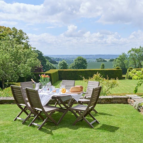 Make the best of sunny days with dining on the lawn overlooking the countryside