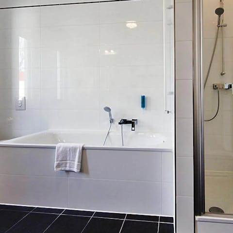 Treat yourself to a luxurious bubble bath in the sparkling modern bathroom 