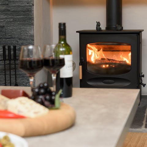 Cosy up by the traditional woodburner with a glass of wine and a cheese board