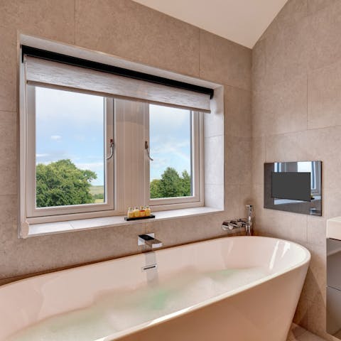 Watch TV in the luxurious bath tub after a day of hiking in the countryside 