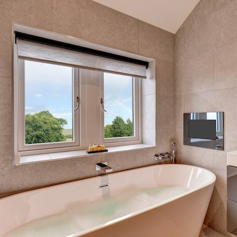 Watch TV in the luxurious bath tub after a day of hiking in the countryside