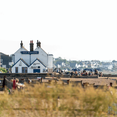 Enjoy a drink at the Old Neptune pub, situated right on the seafront