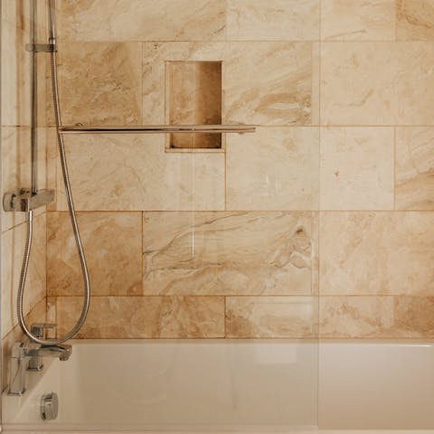 Take a long soak in the honey-coloured bathroom