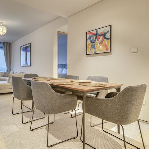 Dine altogether at the wooden table in the light-filled living room
