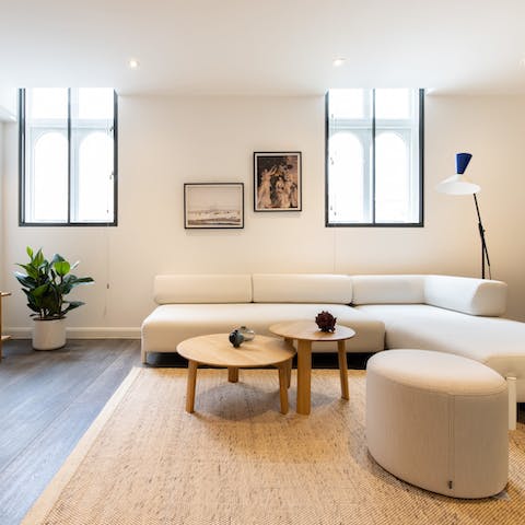 Kick back in the bright living room with a glass of wine after a day of roaming around Soho