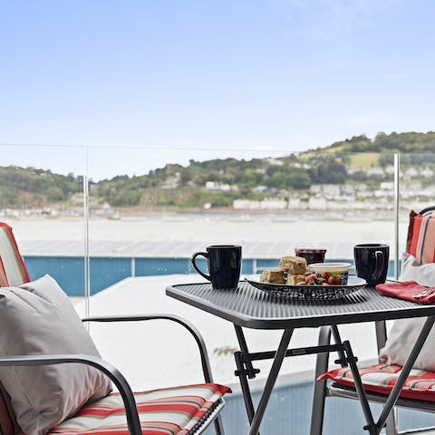 Relax on the balcony with a fruit bowl and a fresh glass of orange juice