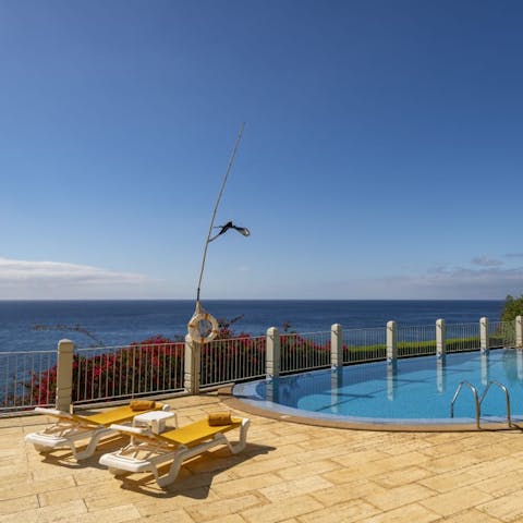 Lounge by the communal pool on the sun loungers with views of the ocean and work on your perfect golden tan