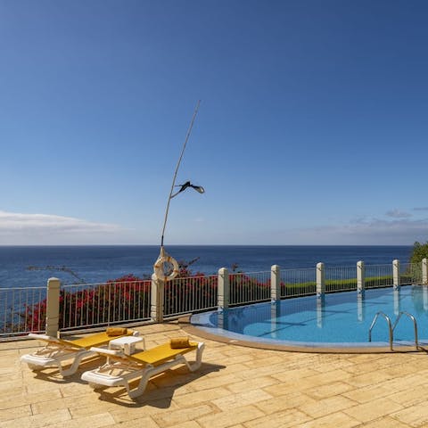 Lounge by the communal pool on the sun loungers with views of the ocean and work on your perfect golden tan