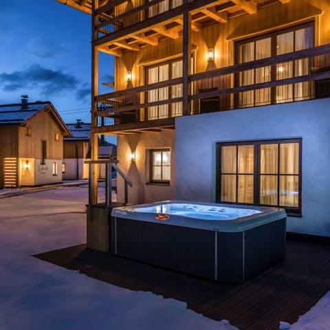 Sip a well-earned glass of bubbly from your private jacuzzi