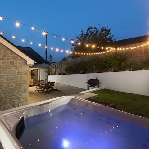 Soak your troubles away in the hot tub under the festoon lights