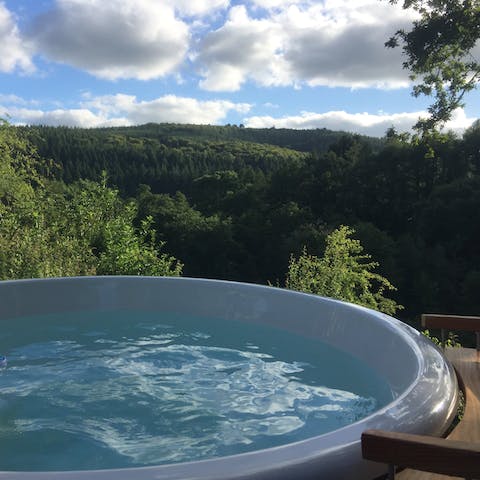 Treat yourself to a soak in the hot tub overlooking the beautiful landscape
