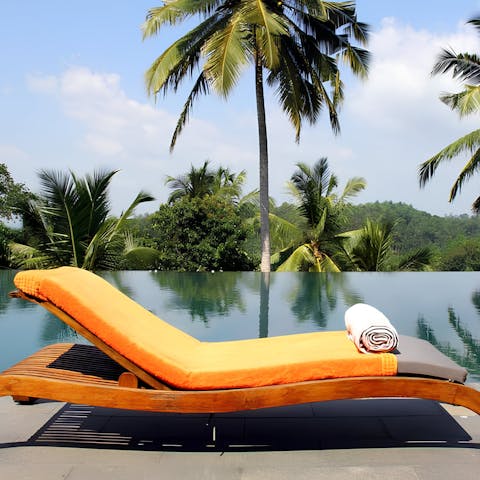 Relax and soak up the sun by the huge infinity pool 