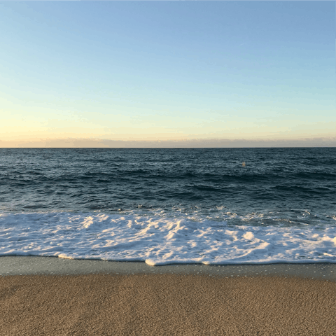 Sink your feet into the golden sands of nearby Arenal Bay