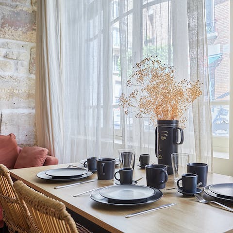 Gather for a breakfast of croissants and coffee around the dining table as the light flood through the big windows