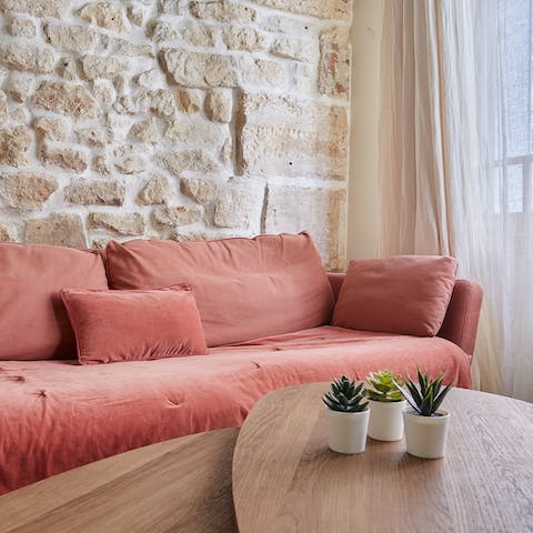 Sink into the rosy-pink sofa and enjoy a glass of French wine after a day of exploring