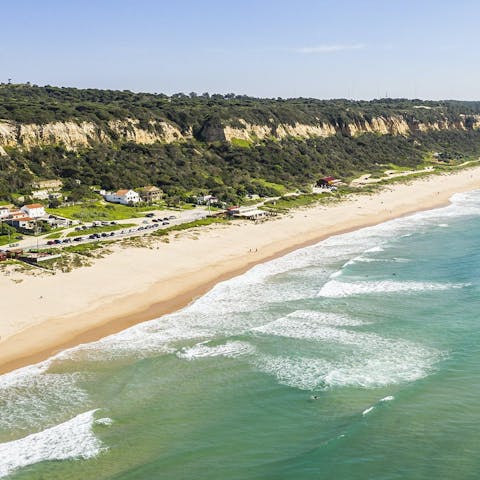 Spend the day on Praia Fonte da Telha, 5 kilometres away