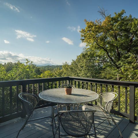 Relax on the deck surrounded by greenery and take in the awe-inspiring views