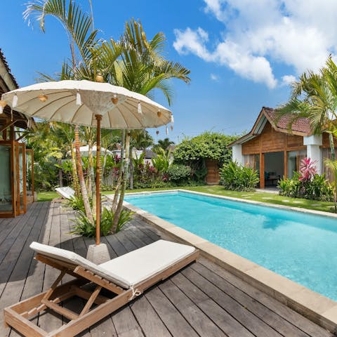 Soak up those blissful moments sunbathing by the tropical pool