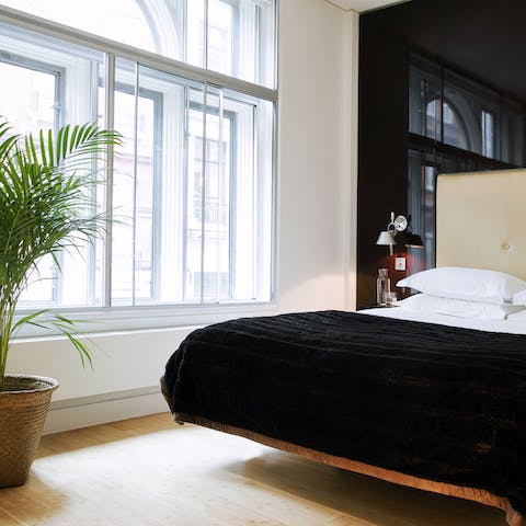 Wake up in a luxury bed next to enormous, original windows