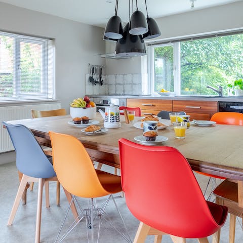 Enjoy group meals in the colourful Eames-style chairs