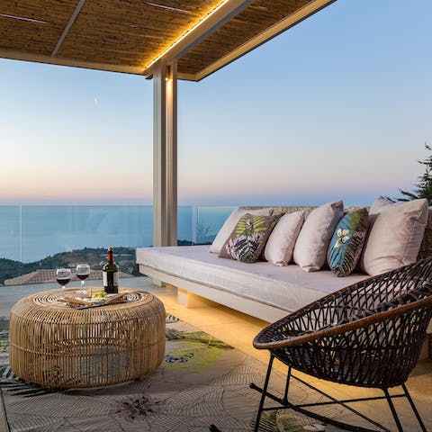 Watch the sunset from the comfortable couch with a glass of wine in hand