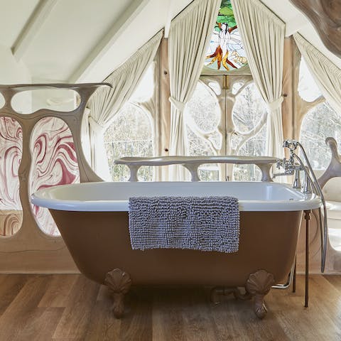 Relax in the freestanding roll-top bath overlooking the garden