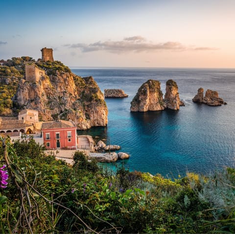 Drive to the coastal village of Scopello – and eat at an authentic restaurant 