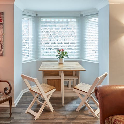 Dine together at the fold-out dining table in the bay window